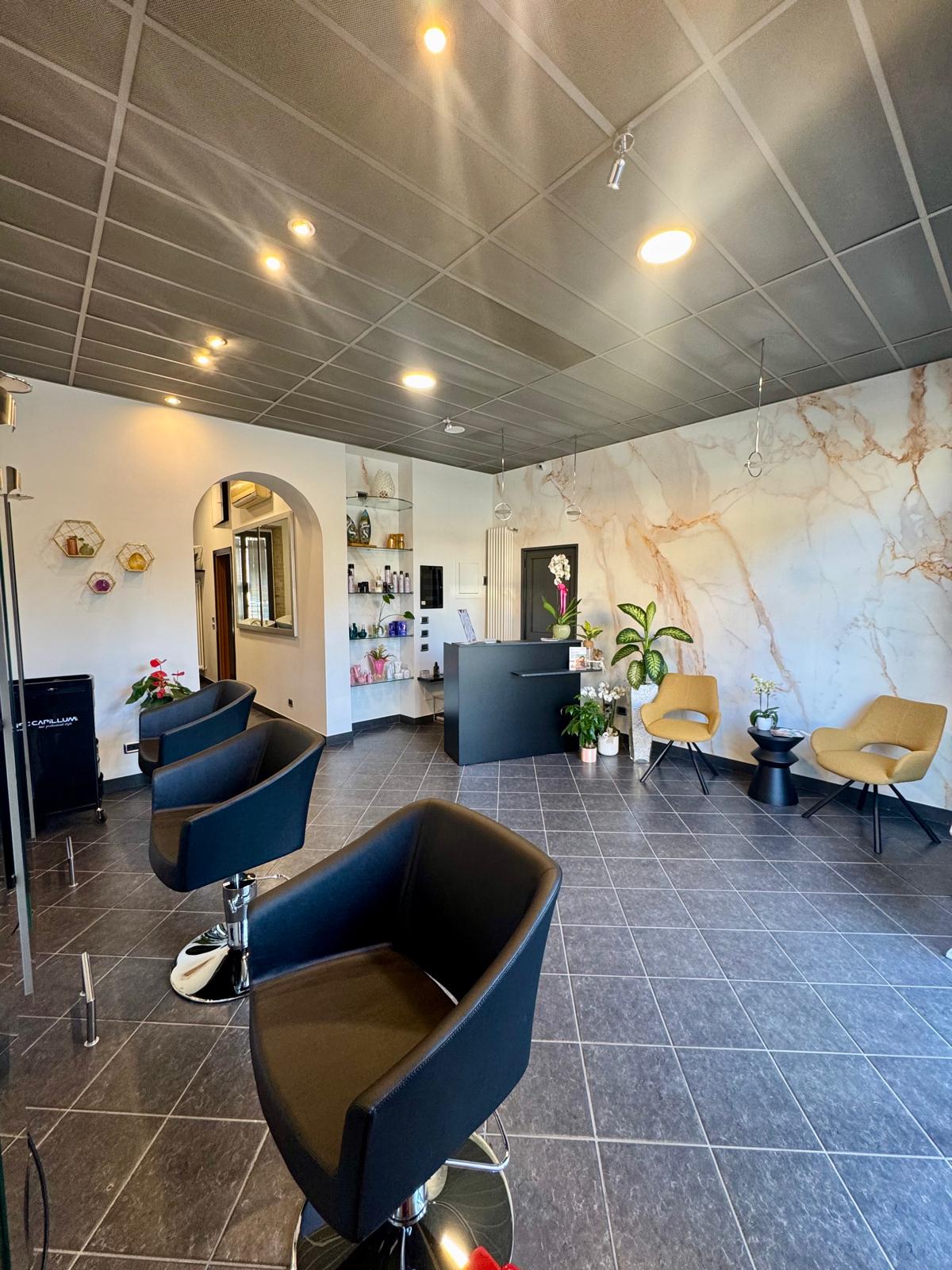 Candid editorial shot of beautiful woman with long wavy hair in luxury salon